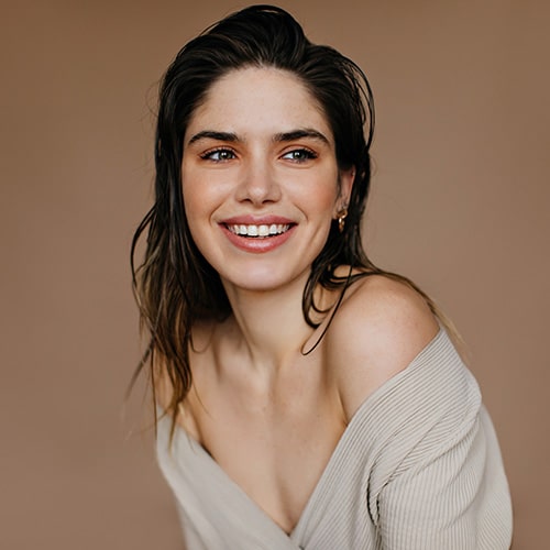 Smiling woman with long brown hair.