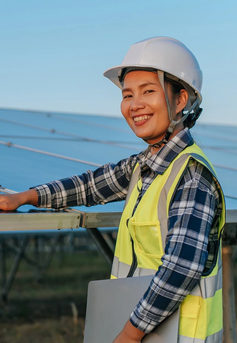 Smiling female solar engineer at work.